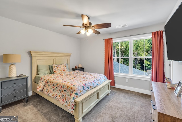 bedroom featuring carpet floors, baseboards, visible vents, and ceiling fan