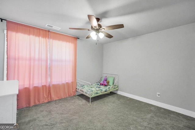 unfurnished bedroom featuring a ceiling fan, carpet, visible vents, and baseboards