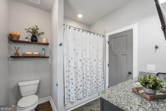 full bathroom with wood finished floors, vanity, toilet, and baseboards