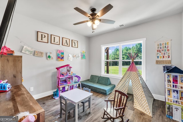 rec room with baseboards, visible vents, ceiling fan, and wood finished floors