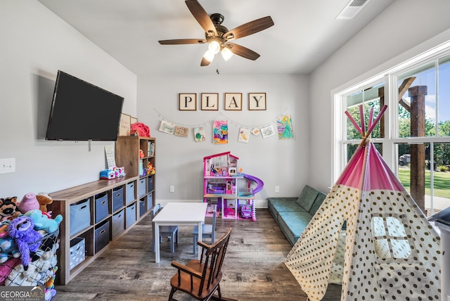 game room with visible vents, dark wood finished floors, and a ceiling fan