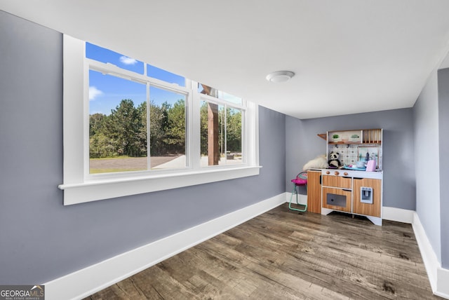 office space with dark wood finished floors and baseboards