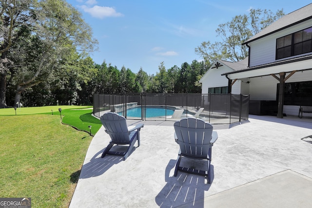 view of pool featuring a patio area, fence, a lawn, and a fenced in pool