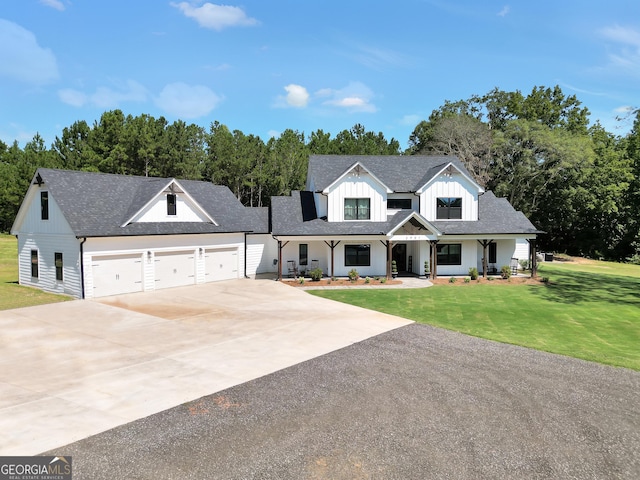 modern farmhouse style home featuring concrete driveway, an attached garage, a front lawn, a porch, and board and batten siding