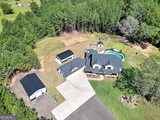 birds eye view of property with a wooded view