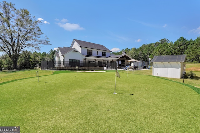 exterior space with a storage shed, fence, an outdoor structure, and a yard