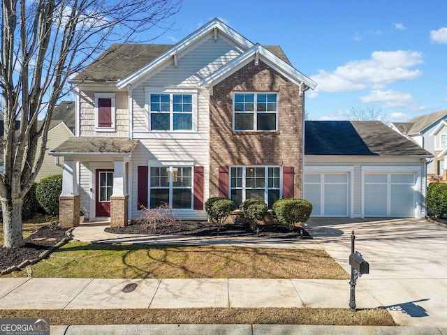 view of front of house featuring concrete driveway, brick siding, and an attached garage