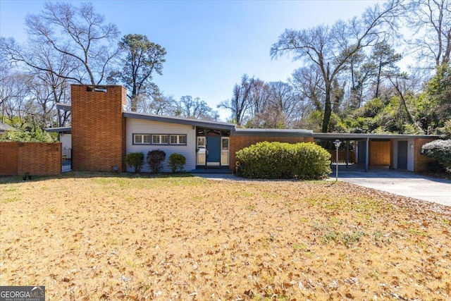 150 Berkley Dr, Macon, GA 31204 - mid-century inspired home featuring a carport, concrete driveway, a chimney, and a front lawn