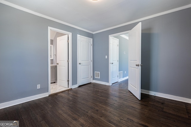 unfurnished bedroom featuring baseboards, visible vents, ornamental molding, dark wood-type flooring, and ensuite bathroom