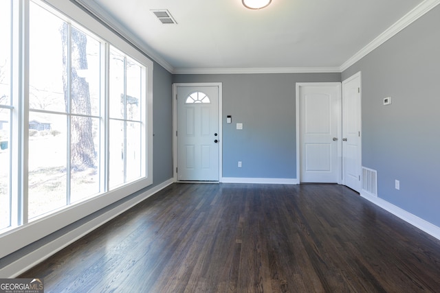 entrance foyer featuring baseboards, visible vents, and ornamental molding