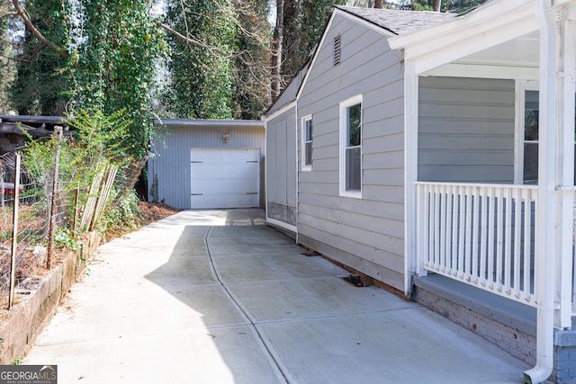 view of home's exterior featuring concrete driveway and roof with shingles