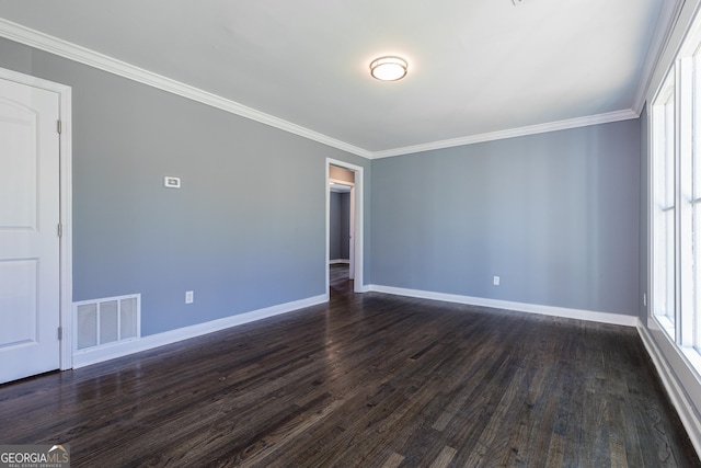 spare room featuring baseboards, visible vents, and dark wood-style flooring