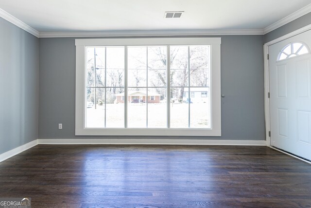 foyer entrance with a healthy amount of sunlight, visible vents, and crown molding