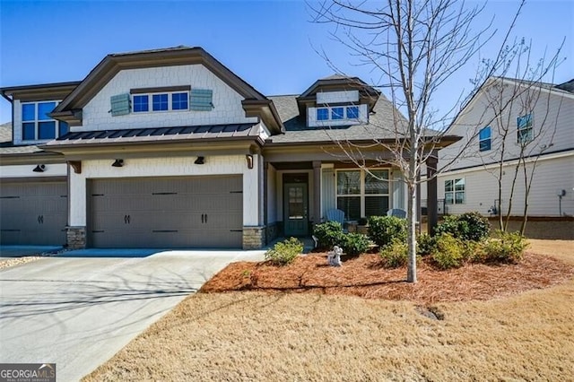 craftsman-style home featuring metal roof, driveway, a standing seam roof, and an attached garage