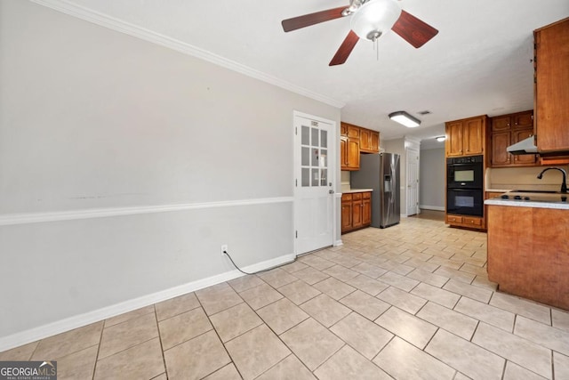 kitchen featuring light tile patterned floors, light countertops, dobule oven black, under cabinet range hood, and stainless steel fridge with ice dispenser