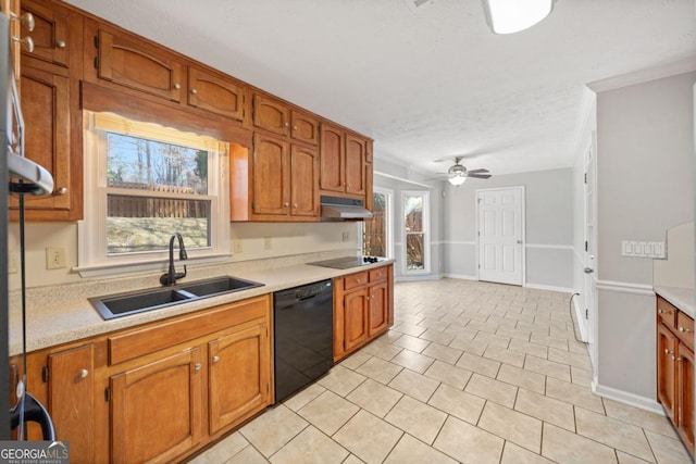 kitchen featuring brown cabinets, under cabinet range hood, light countertops, black appliances, and a sink