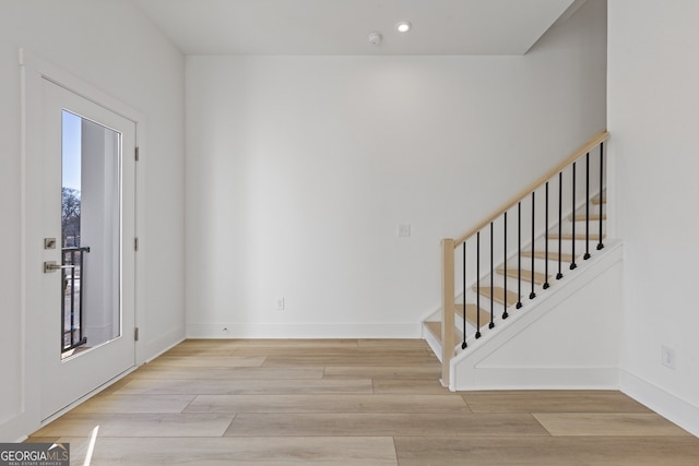 interior space with stairway, recessed lighting, light wood-style flooring, and baseboards