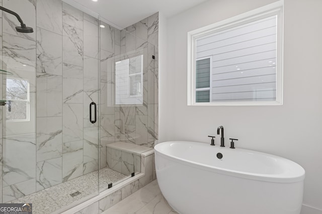 bathroom with a freestanding tub, a marble finish shower, and marble finish floor