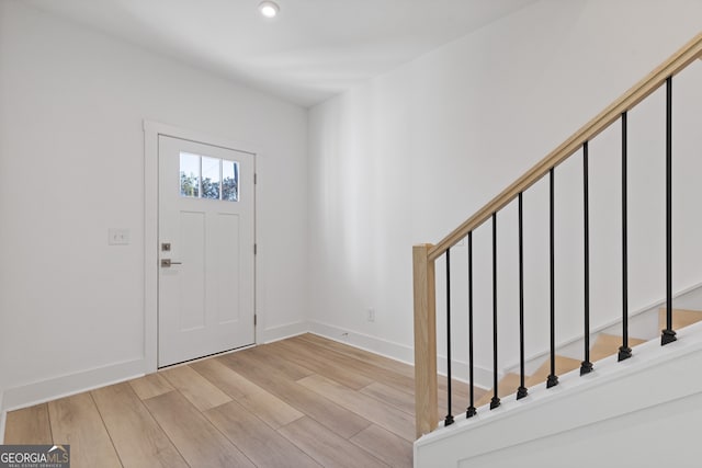 entryway with baseboards, recessed lighting, and light wood-style floors