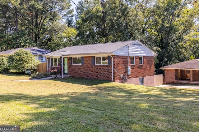 ranch-style house with a front lawn and brick siding