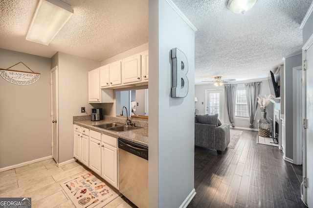 kitchen with a fireplace, light wood-style flooring, white cabinetry, a sink, and dishwasher