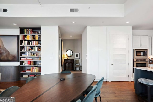 interior space with recessed lighting, visible vents, and dark wood finished floors