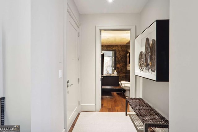 corridor featuring wood finished floors