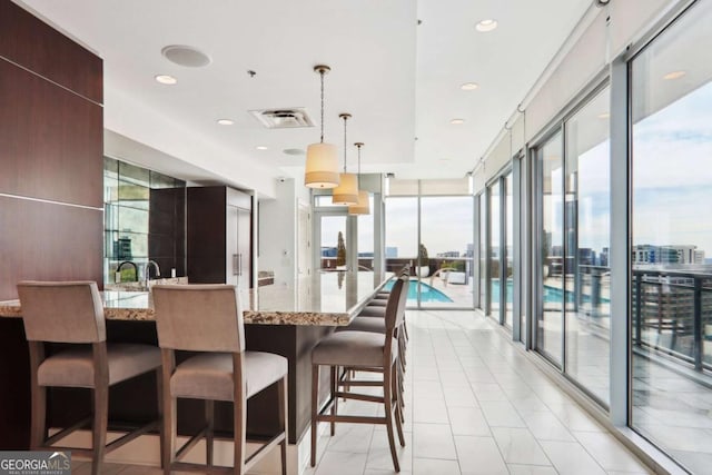 dining space featuring light tile patterned floors, visible vents, recessed lighting, and expansive windows