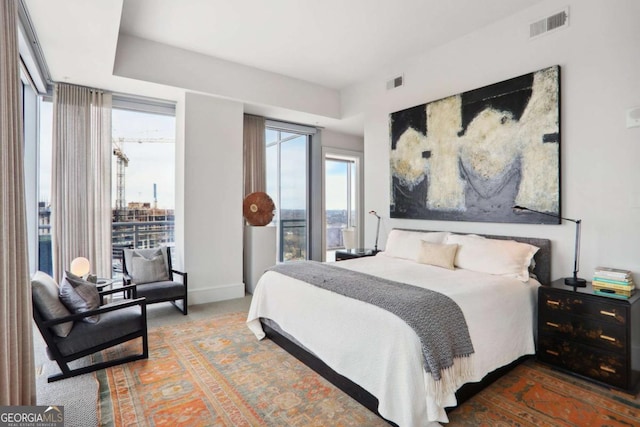 bedroom with visible vents, carpet flooring, and baseboards