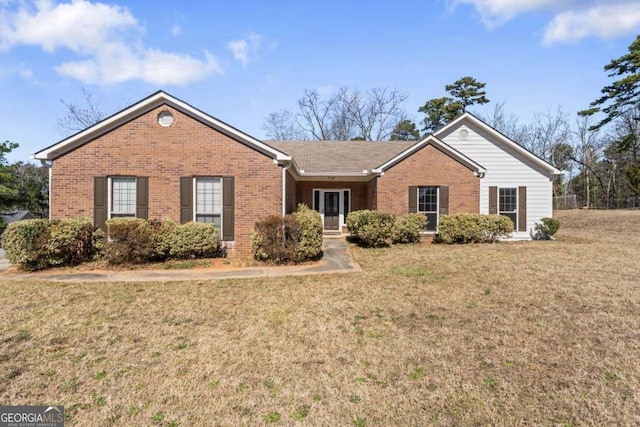 single story home with brick siding and a front lawn