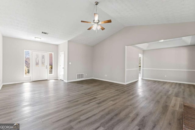 unfurnished living room with baseboards, visible vents, and dark wood-style flooring