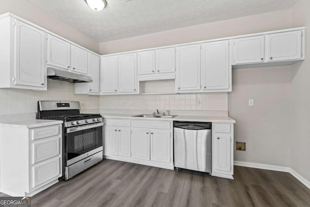 kitchen featuring stainless steel appliances, light countertops, white cabinetry, and under cabinet range hood