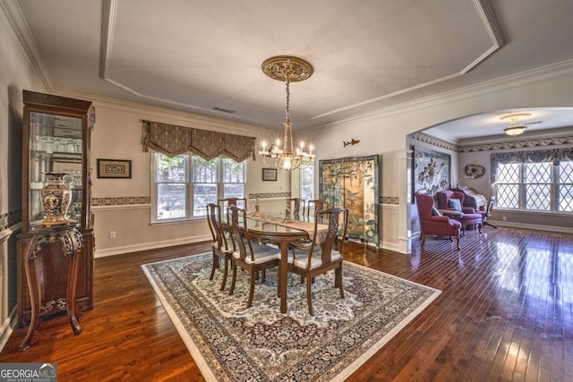 520 Camp Perrin Rd, Lawrenceville, GA 30043 - dining area featuring arched walkways, a chandelier, dark wood-type flooring, and ornamental molding