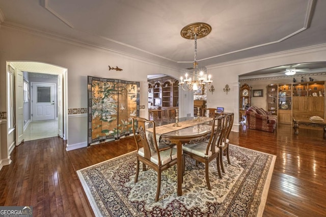 520 Camp Perrin Rd, Lawrenceville, GA 30043 - dining space with dark wood-type flooring, arched walkways, and ornamental molding