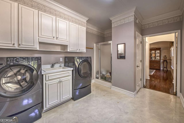 520 Camp Perrin Rd, Lawrenceville, GA 30043 - laundry area featuring arched walkways, crown molding, washer and clothes dryer, cabinet space, and a sink