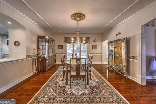 520 Camp Perrin Rd, Lawrenceville, GA 30043 - dining room with dark wood-style floors, arched walkways, ornamental molding, and an inviting chandelier