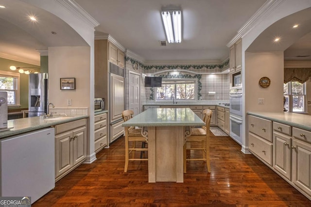 520 Camp Perrin Rd, Lawrenceville, GA 30043 - kitchen featuring ornamental molding, a breakfast bar, a sink, and a center island