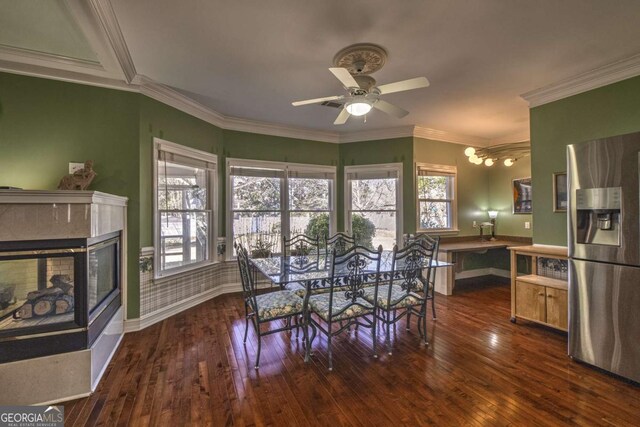 520 Camp Perrin Rd, Lawrenceville, GA 30043 - dining room featuring dark wood-style floors, a healthy amount of sunlight, and a multi sided fireplace