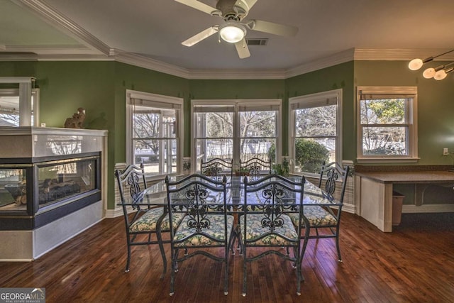 520 Camp Perrin Rd, Lawrenceville, GA 30043 - dining space with dark wood-style floors, visible vents, ornamental molding, and a multi sided fireplace