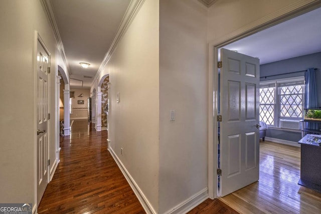 520 Camp Perrin Rd, Lawrenceville, GA 30043 - hallway featuring dark wood-style floors, ornamental molding, arched walkways, and baseboards