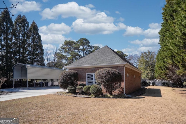 520 Camp Perrin Rd, Lawrenceville, GA 30043 - view of home's exterior with a carport, roof with shingles, concrete driveway, and brick siding