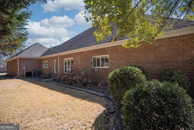 520 Camp Perrin Rd, Lawrenceville, GA 30043 - view of home's exterior featuring a shingled roof, cooling unit, and brick siding