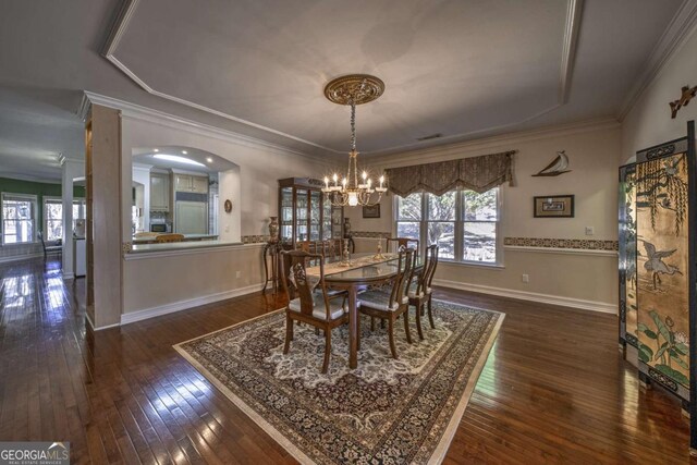 520 Camp Perrin Rd, Lawrenceville, GA 30043 - dining area with a chandelier, dark wood-type flooring, baseboards, and crown molding