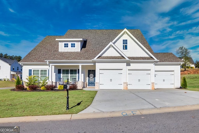 view of front of house with a garage, a shingled roof, concrete driveway, covered porch, and a front yard