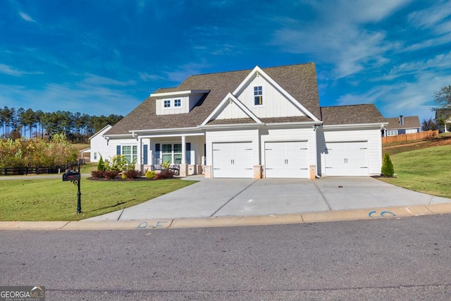 view of front of home featuring a front yard, concrete driveway, roof with shingles, and covered porch