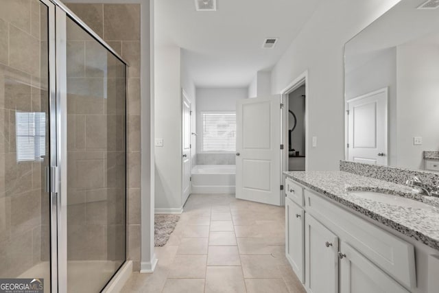 full bathroom with a garden tub, visible vents, a shower stall, vanity, and tile patterned flooring