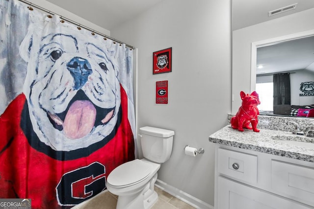 bathroom featuring visible vents, toilet, vanity, tile patterned flooring, and baseboards