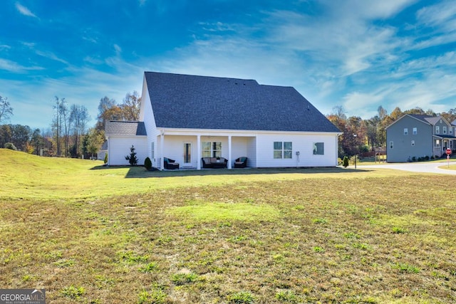 view of front of house with a front lawn and roof with shingles