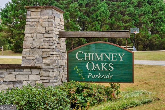 community / neighborhood sign featuring a lawn
