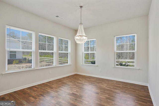 3891 Shelleydale Dr, Powder Springs, GA 30127 - unfurnished dining area featuring a chandelier, visible vents, dark wood finished floors, and baseboards